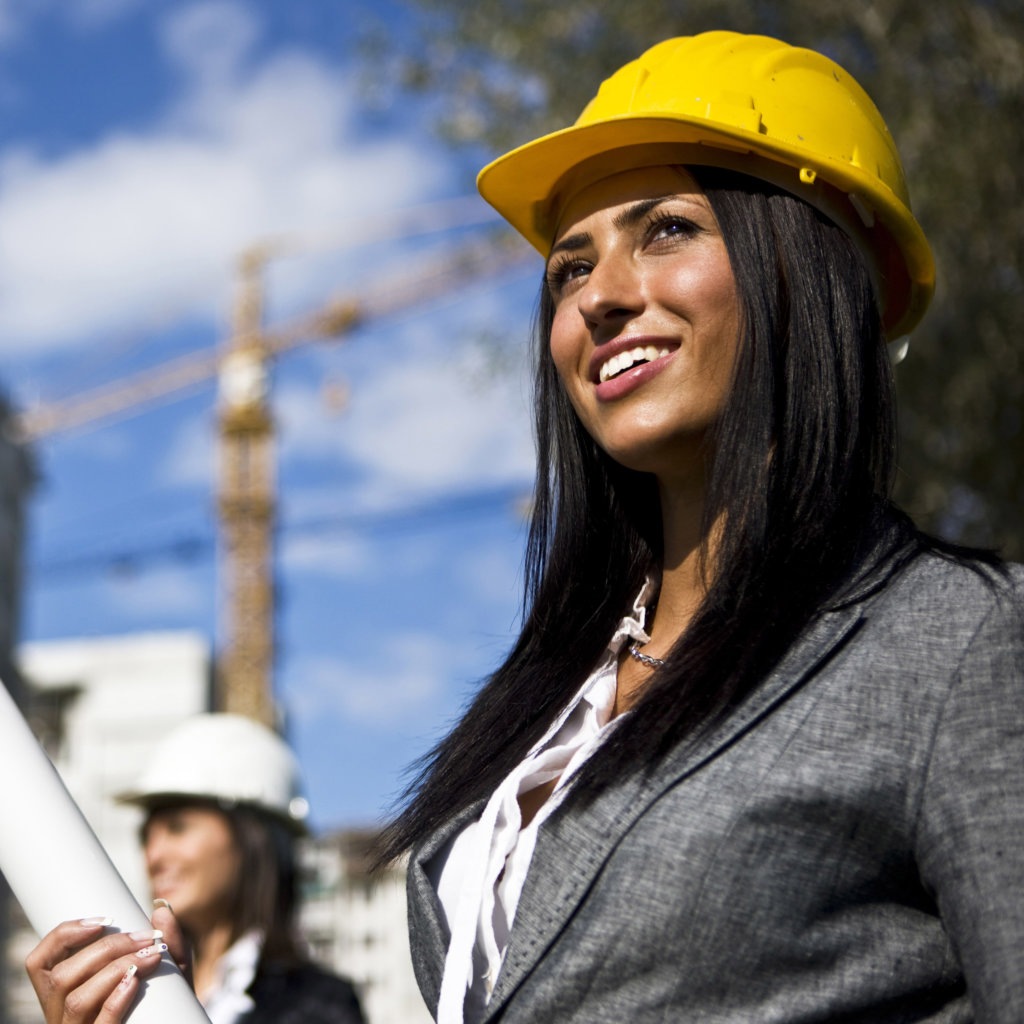 A female general contractor with a yellow hardhat