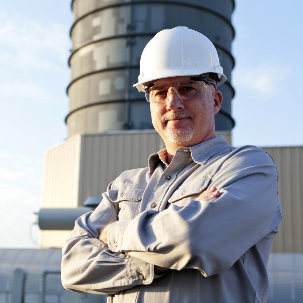 A manager wearing hardhat at an industrial facility
