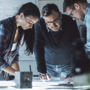 Three fall protection designers having a work meeting to discuss permanent roof anchors